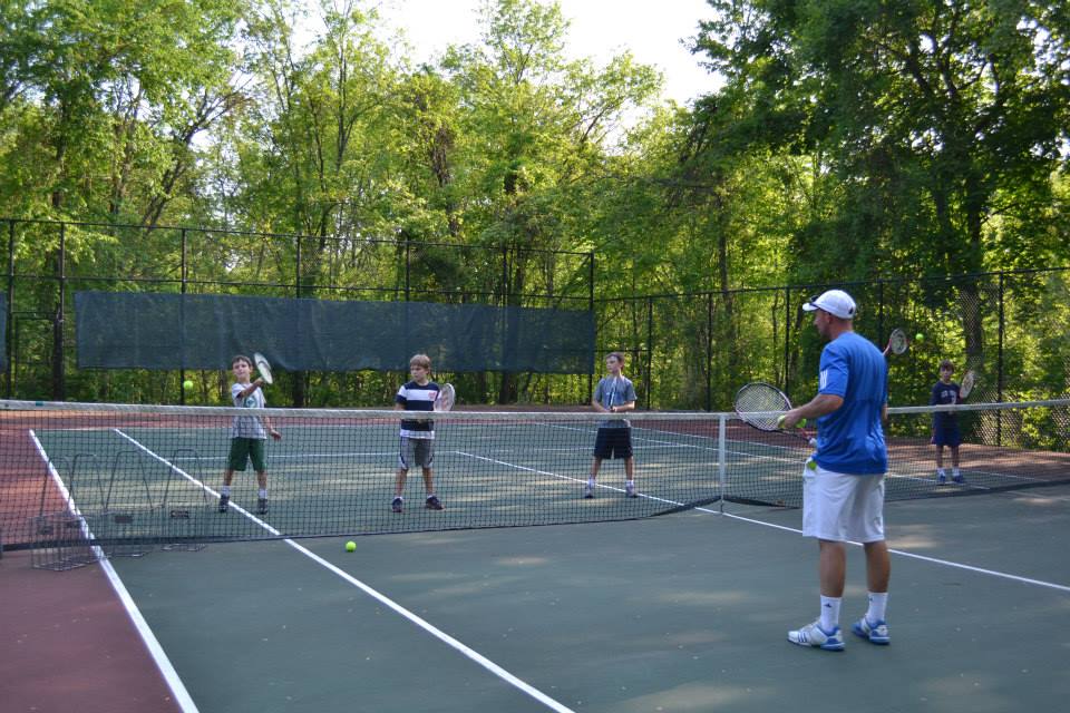 tennis pro teaching children